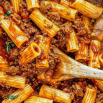 Beef Pasta: A Quick and Comforting Family Dinner 4 Bowl of beef pasta with ground beef, tomato sauce, and melted cheese, garnished with fresh herbs and served with a fork