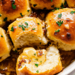 Garlic Brad Rolls - The Ultimate Recipe for Beginners with Easy Steps 2 Golden brown garlic bread rolls with melted butter and herbs, arranged in a basket lined with cloth